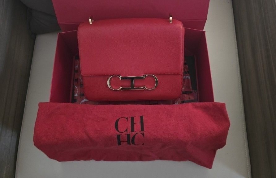 Carolina Herrera Red Shoulder Bag with Gold Hardware (Category: Luxury Bags & Wallets) located in Manila. Submitted by k.lvd (Listing ID 1452303643, Image 1). Description: -Authentic Carolina Herrera Red Initials Insignia Crossbody Bag. -Features the iconic gold CH logo hardware. -Crafted from premium leather in a striking red finish. -Includes the original dust bag and box. -Comes with an extra top handle for versatile hand-carry styling. -Adjus