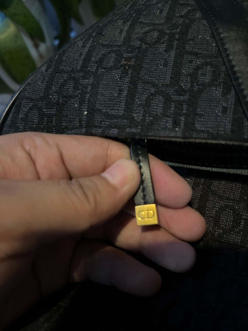 Christian Dior Saddle Bag Oblique Canvas (Category: Luxury Bags & Wallets) located in Cagayan de Oro. Submitted by zaybans.lux2 (Listing ID 1452126723, Image 2). Description: - Christian Dior Saddle Bag - Iconic Dior Oblique Canvas (Black & Grey) - Genuine Leather Trim and Strap - Gold-tone Hardware - Interior Zip Pocket - Made in Italy - Serial number visible in photos.