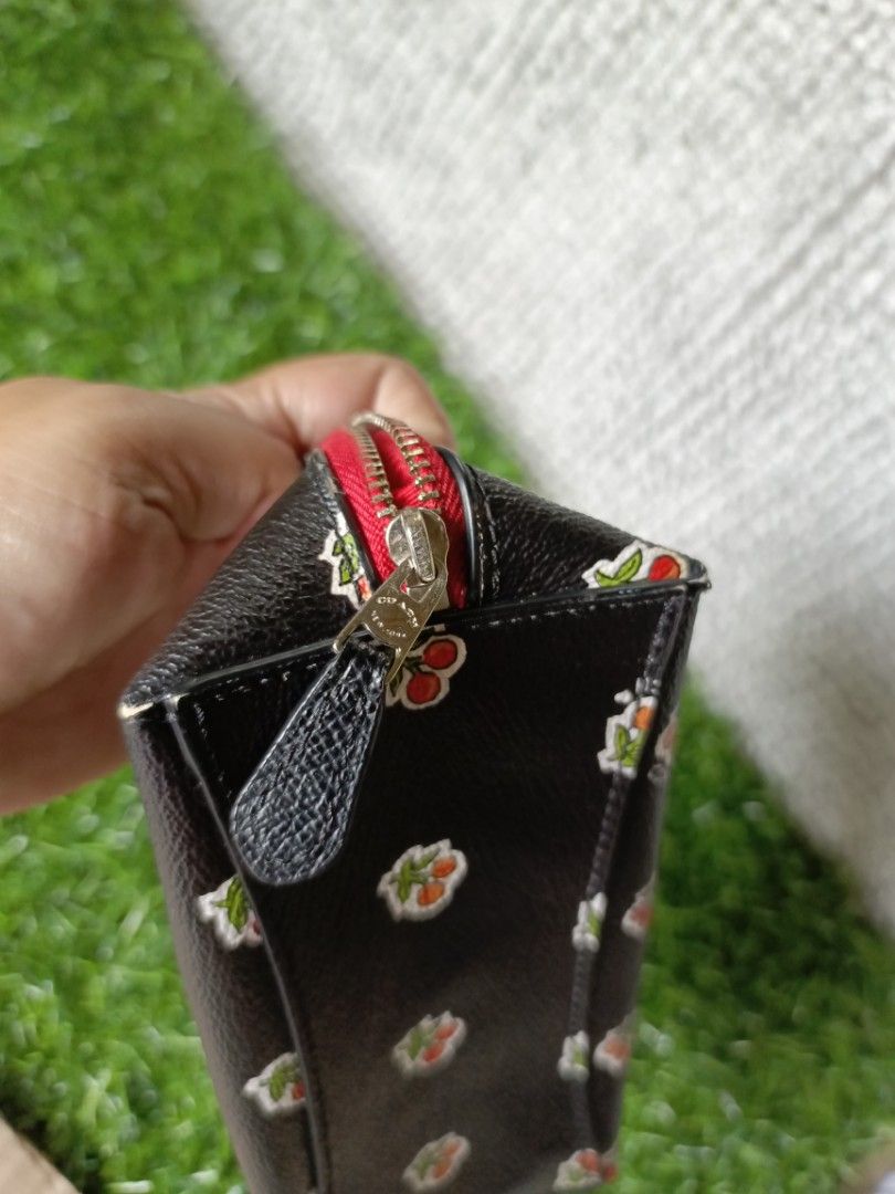 Coach Black Cherry Print Cosmetic Bag Pouch (Category: Purses & Pouches) located in Subic. Submitted by addiestrend (Listing ID 1452165604, Image 3). Description: FREE WITH 1K WORTH OF PURCHASE FROM MY LISTING - Adorable Coach cosmetic bag - Stylish black with a playful cherry print - Eye-catching red zipper detail - Vibrant bright red interior - Ideal for storing makeup or other small essentials - Compact size: approximately 7 inches long flaw: 