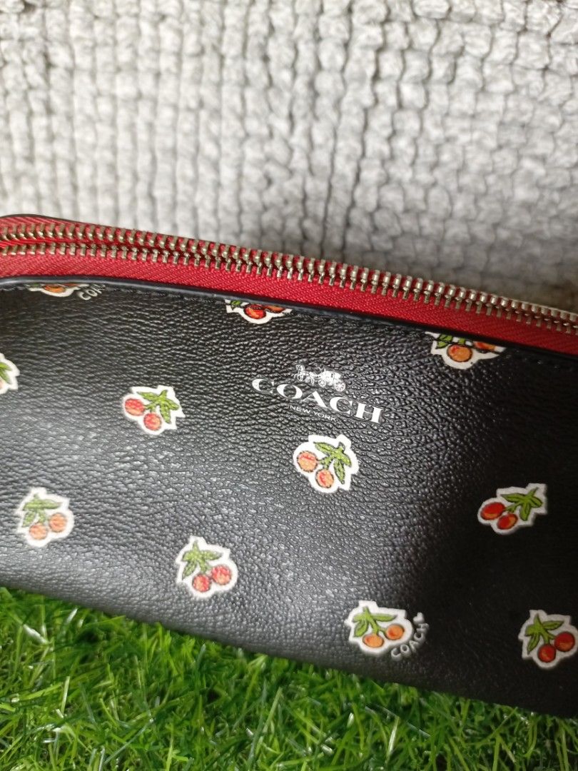 Coach Black Cherry Print Cosmetic Bag Pouch (Category: Purses & Pouches) located in Subic. Submitted by addiestrend (Listing ID 1452165604, Image 2). Description: FREE WITH 1K WORTH OF PURCHASE FROM MY LISTING - Adorable Coach cosmetic bag - Stylish black with a playful cherry print - Eye-catching red zipper detail - Vibrant bright red interior - Ideal for storing makeup or other small essentials - Compact size: approximately 7 inches long flaw: 