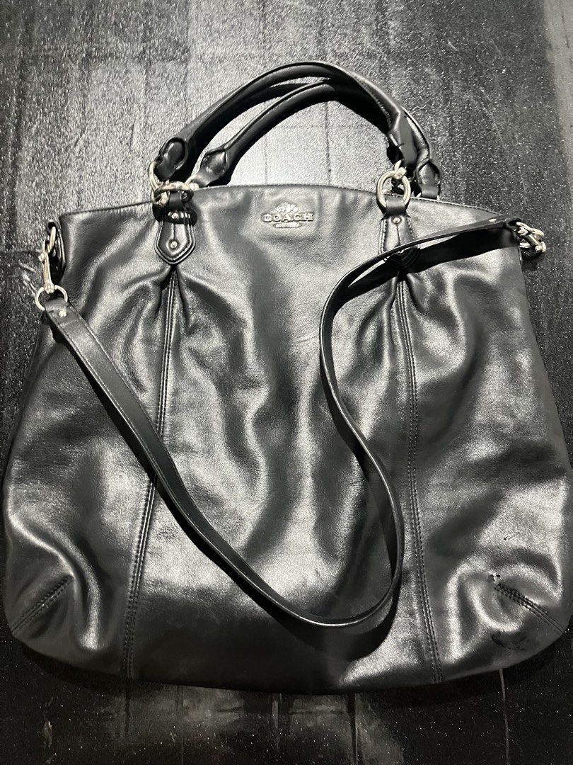 Coach Black Leather Shoulder Bag (Category: Shoulder Bags) located in Rizal. Submitted by oddflower_0b1b39 (Listing ID 1452208235, Image 1). Description: - Genuine black leather Coach handbag - Versatile with top handles and a detachable shoulder strap - Elegant silver hardware details - Spacious interior for all your essentials - Ideal for everyday wear and stylish outings.