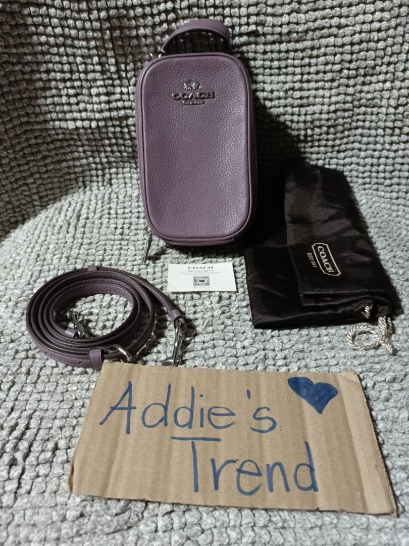 Coach Purple Leather sling with Strap and Dust Bag (Category: Luxury Bags & Wallets) located in Subic. Submitted by addiestrend (Listing ID 1452159656, Image 1). Description: - Adorable purple Coach pouch - Crafted from textured leather - Convenient top handle - Detachable crossbody strap for versatile wear - Interior card slots for organization - Comes with original dust bag - Includes authenticity card -flawless complete inclusion.