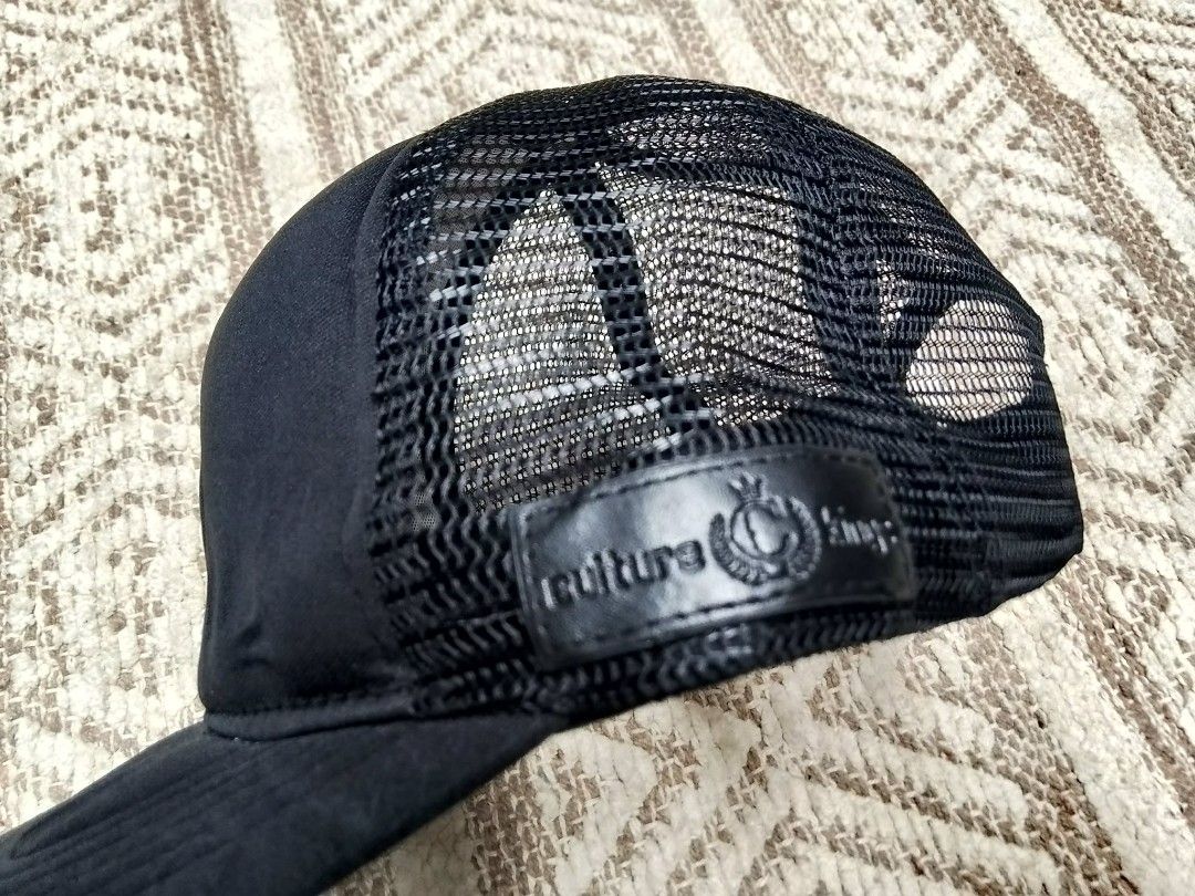 Culture Kings Black Trucker Cap (Category: Caps & Hats) located in Quezon City. Submitted by cruz_robert (Listing ID 1452223296, Image 3). Description: - Brand: Culture Kings - Style: Black Trucker Cap - Features: Embroidered logo on front, paisley pattern under brim - Design: Mesh back for breathability - Fit: Adjustable snapback closure - Ideal for: Everyday wear.