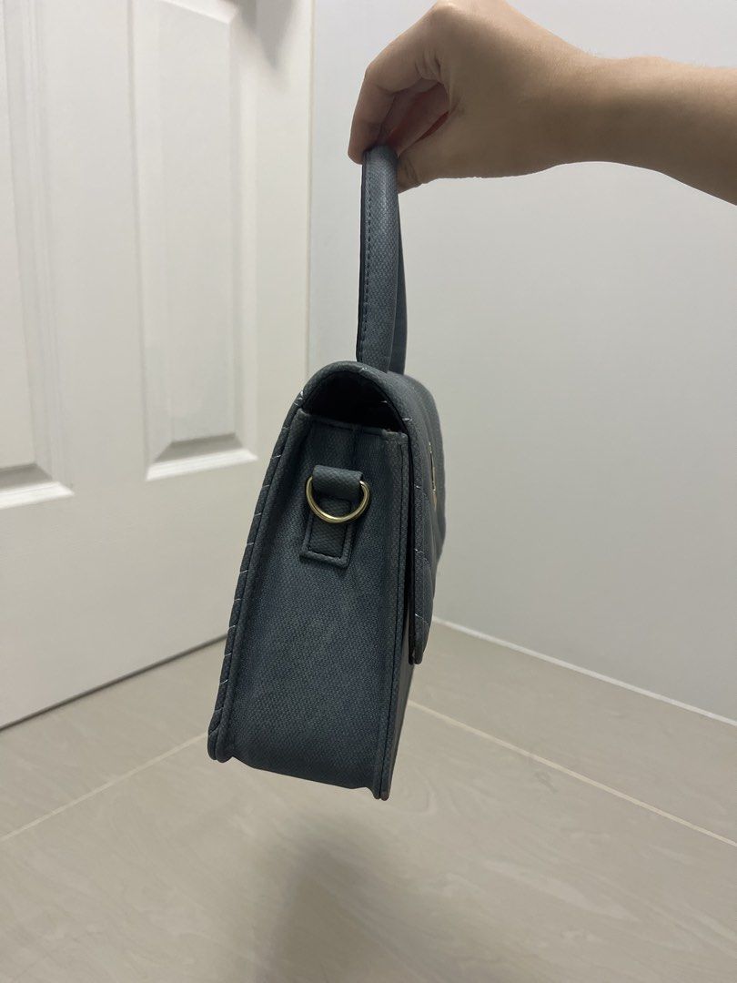 Dark Teal Quilted Handbag with Bee Charm (Category: Luxury Bags & Wallets) located in Binan City. Submitted by machatto.declutter (Listing ID 1452276453, Image 3). Description: - Adorable dark teal handbag - Stylish quilted pattern all over - Cute bee charm on the front flap - Secure magnetic closure - Interior zippered pocket and slip pocket - Sturdy handle for comfortable carrying - Versatile: can be worn as a crossbody (strap not pictured) - I