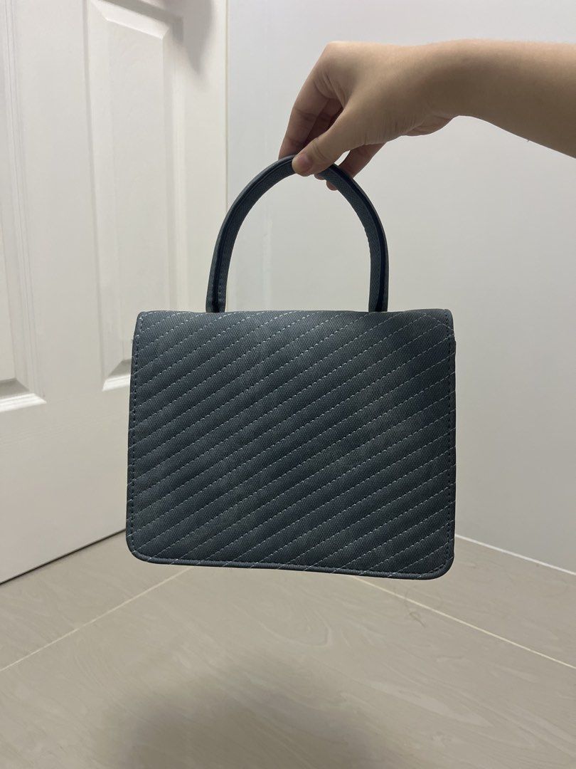 Dark Teal Quilted Handbag with Bee Charm (Category: Luxury Bags & Wallets) located in Binan City. Submitted by machatto.declutter (Listing ID 1452276453, Image 2). Description: - Adorable dark teal handbag - Stylish quilted pattern all over - Cute bee charm on the front flap - Secure magnetic closure - Interior zippered pocket and slip pocket - Sturdy handle for comfortable carrying - Versatile: can be worn as a crossbody (strap not pictured) - I