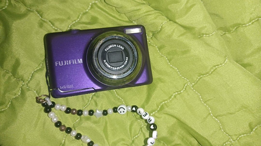 Fujifilm Digital Camera 14 Mega Pixels Purple (Category: Cameras) located in Siay. Submitted by bebengabunoas (Listing ID 1452238807, Image 1). Description: - Fujifilm Digital Camera - Color: Purple - 14 Megapixels - Includes cute beaded strap - Screen has white lines but works perfectly - Ideal for casual photography and preserving memories - Takes good quality pictures - Ready for its new owner! .