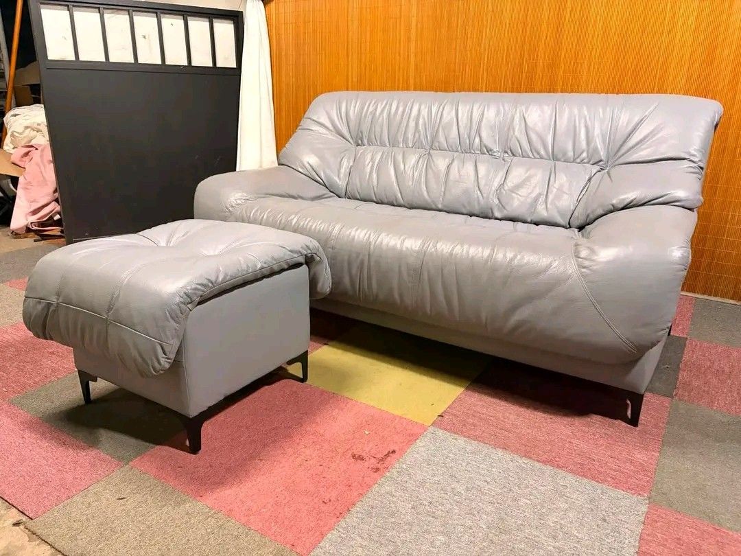 Grey Leather Sofa with Matching Ottoman (Category: Sofas) located in Manila. Submitted by eloizavill76462 (Listing ID 1452143054, Image 2). Description: Modern-Retro Gray Leather Sofa with Ottoman SUPER COMFY!!! THICK LEATHER FABRIC!!! RETRO VIBES!!! NO ISSUES!!! FLAWLESS!!! *SEE VIDEO COMMENT Sofa : 61L x 34W x 18H seat height inches Sandalan height 32 inches Ottoman : 29L x 19W x 18H inches In VERY good condition .