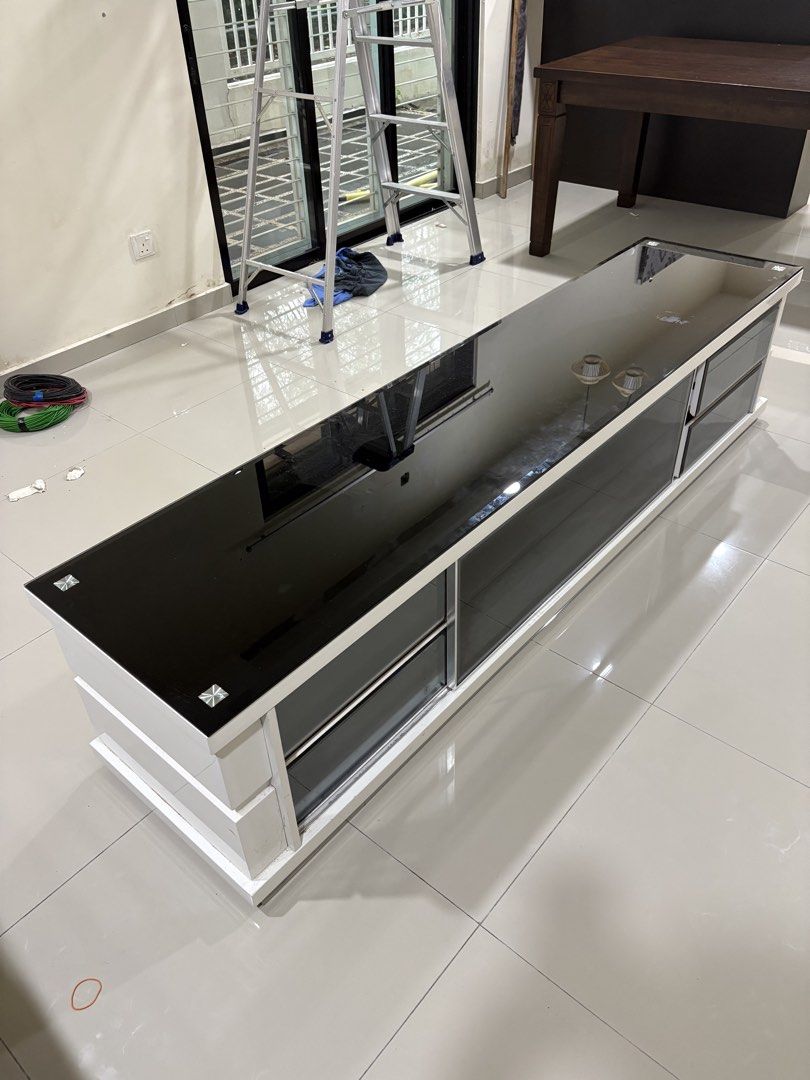High Quality Modern TV Cabinet / Console 6.8ft (Category: TV Consoles) located in Senai. Submitted by fitrinazmi (Listing ID 1452251470, Image 1). Description: Condition : 8/10 Dimension : 6.8ft L x 1.5ft W x 1.5ft H Material : High Grade Wood ( Super Heavy) Colour : White Accessories : spotlight, glass top cover, glass compartment cover Reason to sell : house clearance Nego till let go Self Pickup / buyer to arrange delivery, Nilai, Negeri Sembi