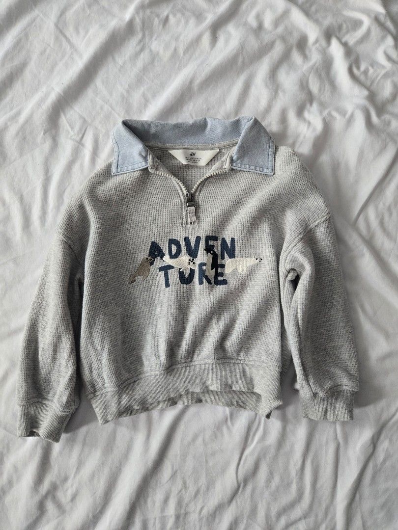 H&M Grey Adventure Zip-Up Sweater (2T) (Category: Babies & Kids Fashion) located in Manila. Submitted by shla.dln (Listing ID 1452167844, Image 1). Description: - Grey waffle knit sweater from H&M - Blue collar and zipper at the neck - 'ADVENTURE' text with llama graphics on the front - Ideal for everyday wear - Easy to put on and take off.