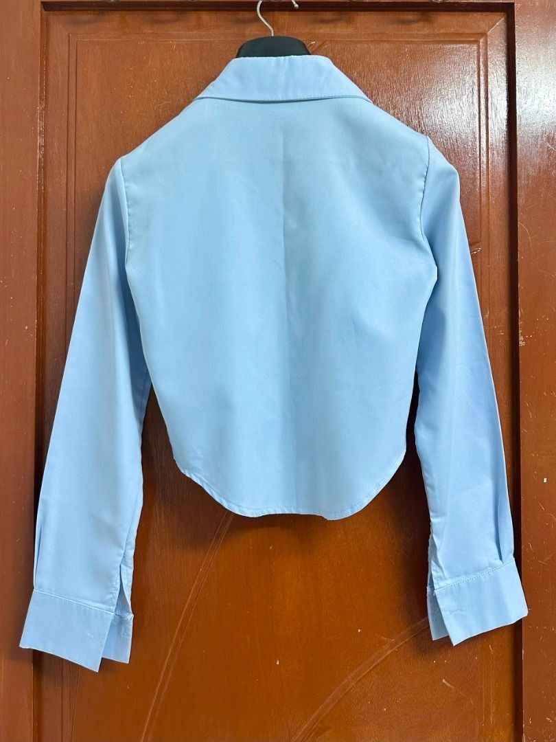 Light Blue Cropped Button-Up Shirt (Category: Longsleeves) located in Georgetown. Submitted by vonneeeeee (Listing ID 1452192362, Image 3). Description: - Shoulder 31.5cm - Sleeve 57cm - Length 42 - 48cm - Slight stains on sleeve parts - Condition 7/10 *PURCHASE RM25 & ABOVE FREE SHIPPING‼️ ‼️.