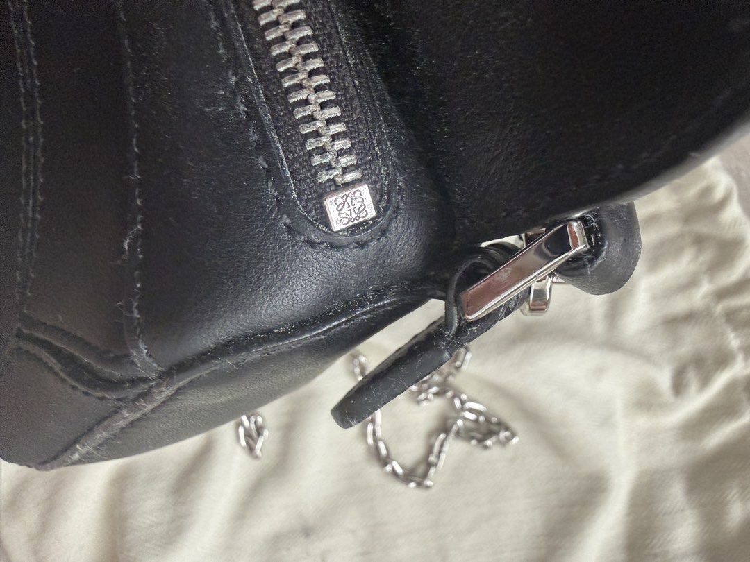 Loewe Black Leather Puzzle Mini Bag with Dust Bag (Category: Luxury Bags & Wallets) located in Antipolo. Submitted by 2ammom (Listing ID 1452136521, Image 3). Description: - Black Leather Loewe Puzzle Bag - Mini Size - Includes Dust Bag - Palladium Chain Strap - Zipper Closure - Embossed Loewe Logo on Flap and Zipper Pull - Ideal for carrying wallets, cards and small items.