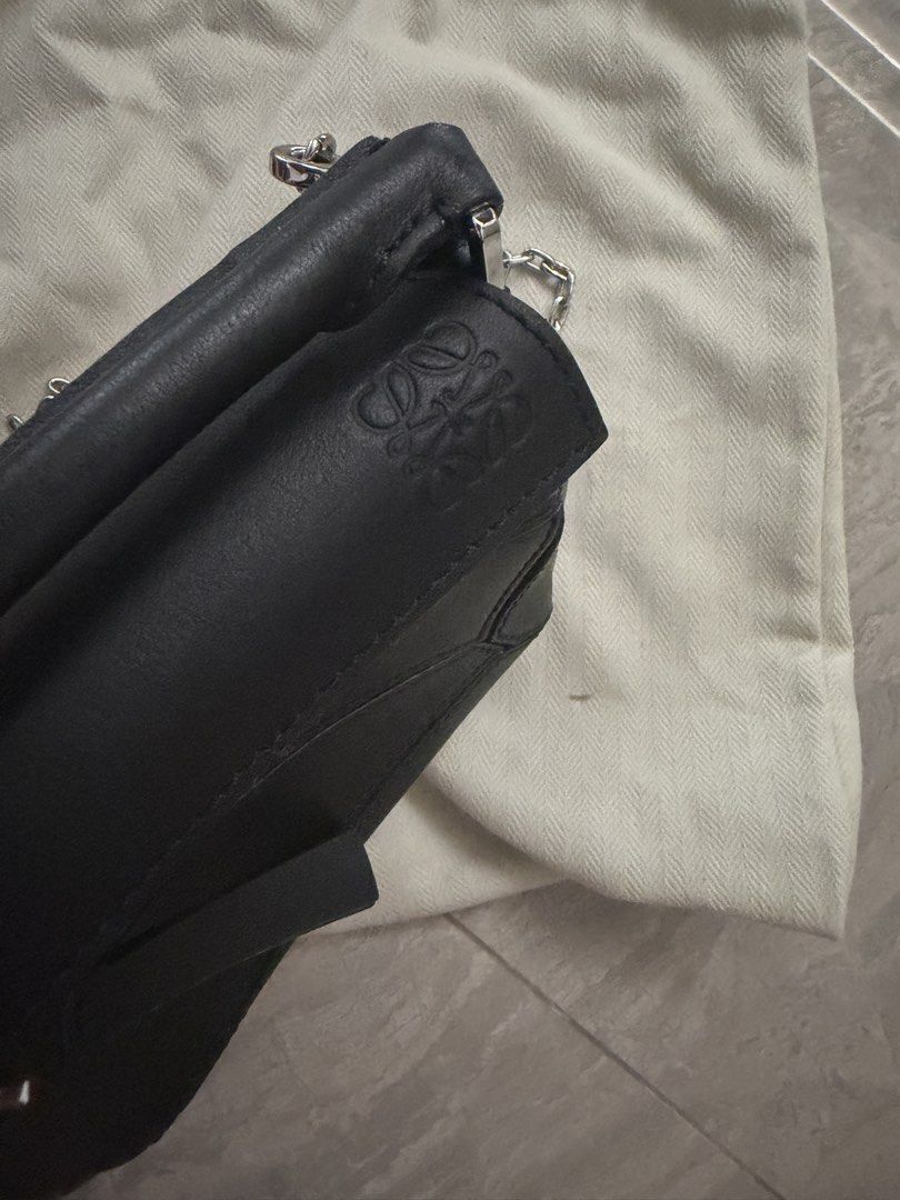 Loewe Black Leather Puzzle Mini Bag with Dust Bag (Category: Luxury Bags & Wallets) located in Antipolo. Submitted by 2ammom (Listing ID 1452136521, Image 2). Description: - Black Leather Loewe Puzzle Bag - Mini Size - Includes Dust Bag - Palladium Chain Strap - Zipper Closure - Embossed Loewe Logo on Flap and Zipper Pull - Ideal for carrying wallets, cards and small items.