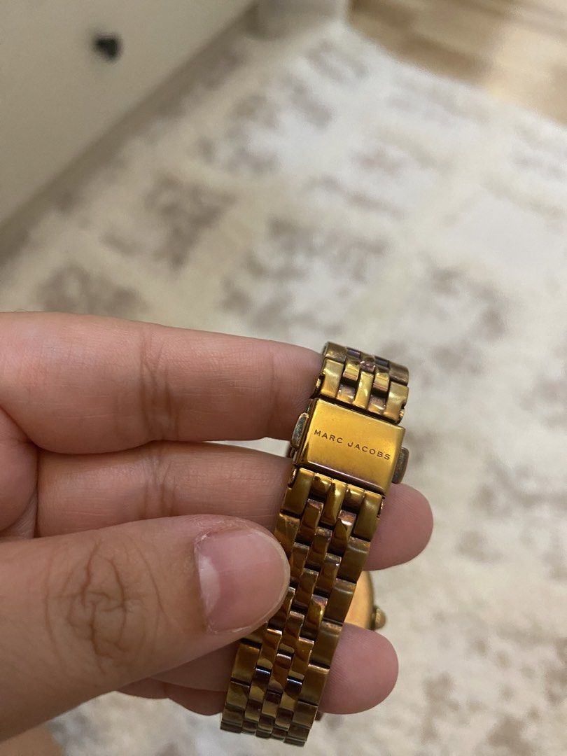 Marc Jacobs Gold Tone Watch (Category: Women's Watches) located in Bulacan. Submitted by aksantos10 (Listing ID 1452214011, Image 3). Description: - Gold tone Marc Jacobs watch - Features iconic MJ logo on the face - Gold tone band - Classic and versatile design - Perfect for everyday wear or dressing up.