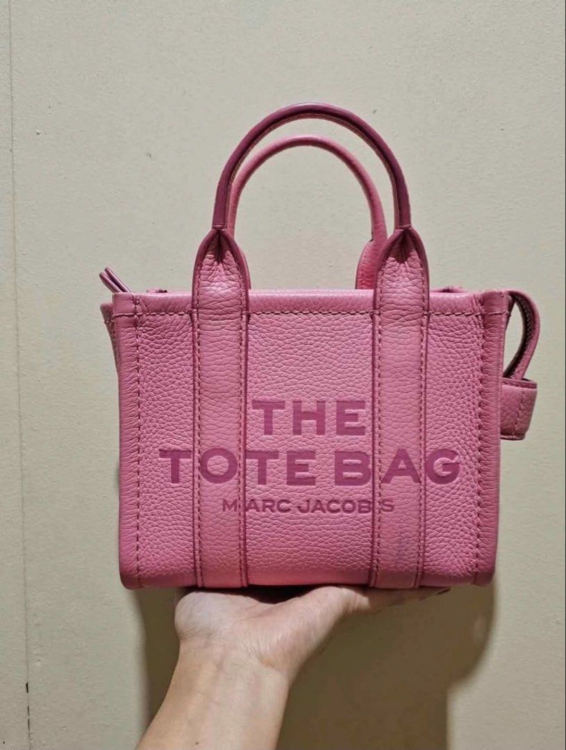 Marc Jacobs The Tote Bag Mini Pink Leather (Category: Luxury Bags & Wallets) located in Quezon City. Submitted by shesells_seashells9 (Listing ID 1452146168, Image 1). Description: - Authentic Marc Jacobs Mini Tote Bag - Material: Pebbled Leather - Color: Bright Pink - Features: Embossed logo on front - Includes: Dust bag and authenticity cards - Perfect for carrying your essentials.