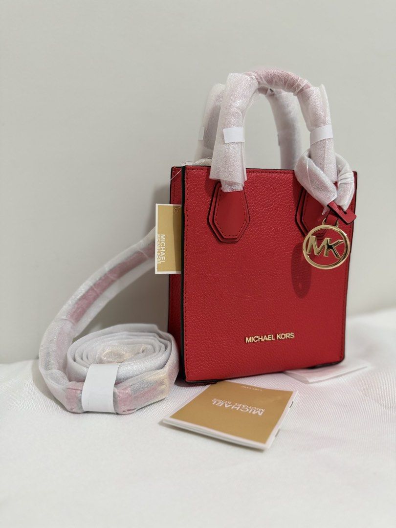 Michael Kors Mini Mercer Red Leather Mini Tote Bag (Category: Luxury Bags & Wallets) located in Angeles City. Submitted by kimkim_06_614 (Listing ID 1452261192, Image 2). Description: - Authentic Michael Kors Mini Tote Bag - Color: Bright Red - Material: Pebbled Leather - Hardware: Gold Tone - Accent: MK Charm - Strap: Detachable Crossbody Strap Included - Condition: Brand New with Original Tags and Care Card - Size: Perfect for carrying essentia