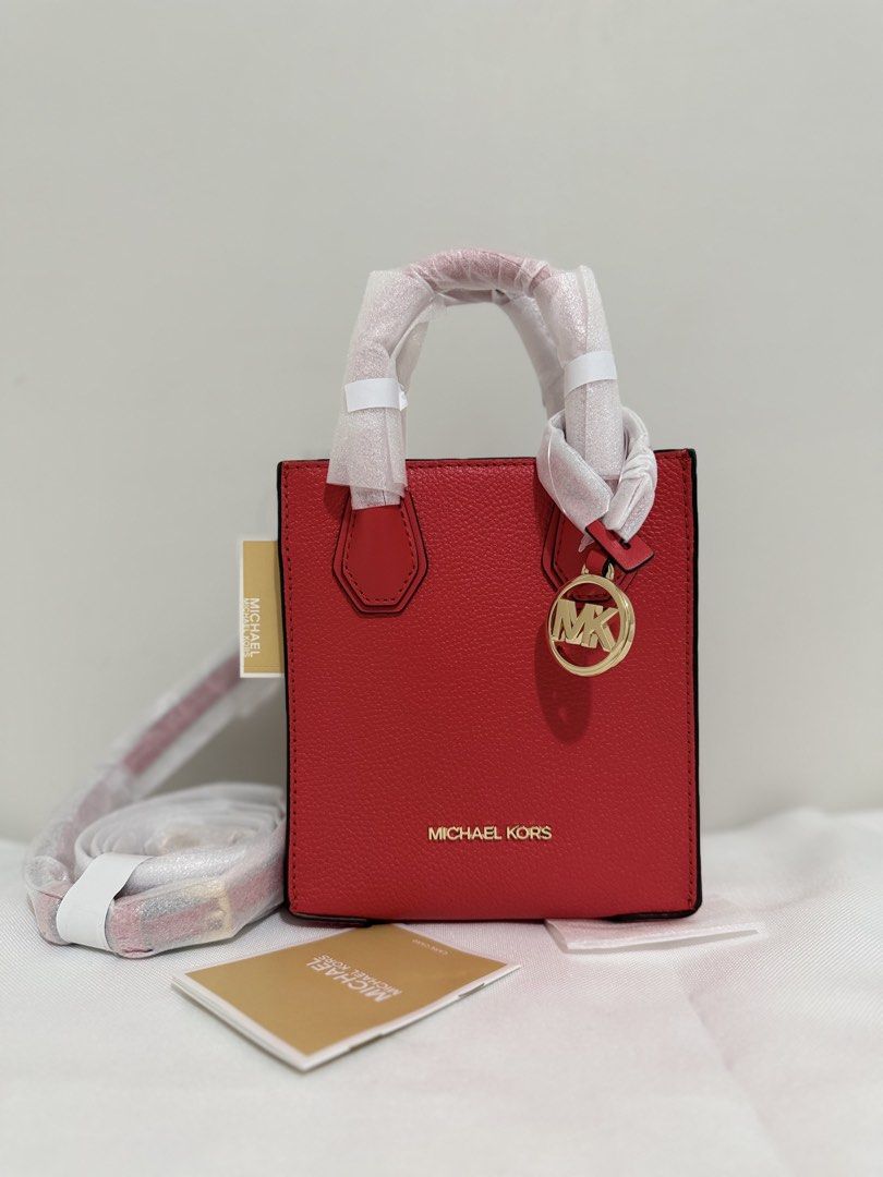 Michael Kors Mini Mercer Red Leather Mini Tote Bag (Category: Luxury Bags & Wallets) located in Angeles City. Submitted by kimkim_06_614 (Listing ID 1452261192, Image 1). Description: - Authentic Michael Kors Mini Tote Bag - Color: Bright Red - Material: Pebbled Leather - Hardware: Gold Tone - Accent: MK Charm - Strap: Detachable Crossbody Strap Included - Condition: Brand New with Original Tags and Care Card - Size: Perfect for carrying essentia