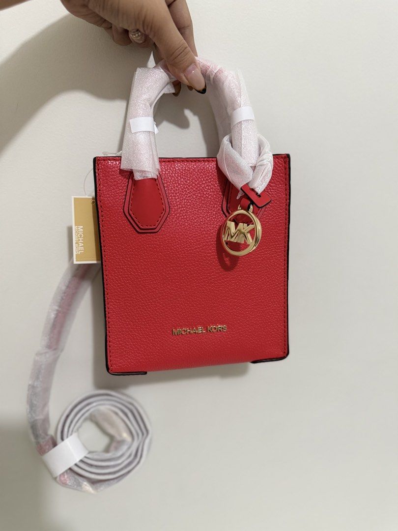 Michael Kors Mini Mercer Red Leather Mini Tote Bag (Category: Luxury Bags & Wallets) located in Angeles City. Submitted by kimkim_06_614 (Listing ID 1452261192, Image 3). Description: - Authentic Michael Kors Mini Tote Bag - Color: Bright Red - Material: Pebbled Leather - Hardware: Gold Tone - Accent: MK Charm - Strap: Detachable Crossbody Strap Included - Condition: Brand New with Original Tags and Care Card - Size: Perfect for carrying essentia