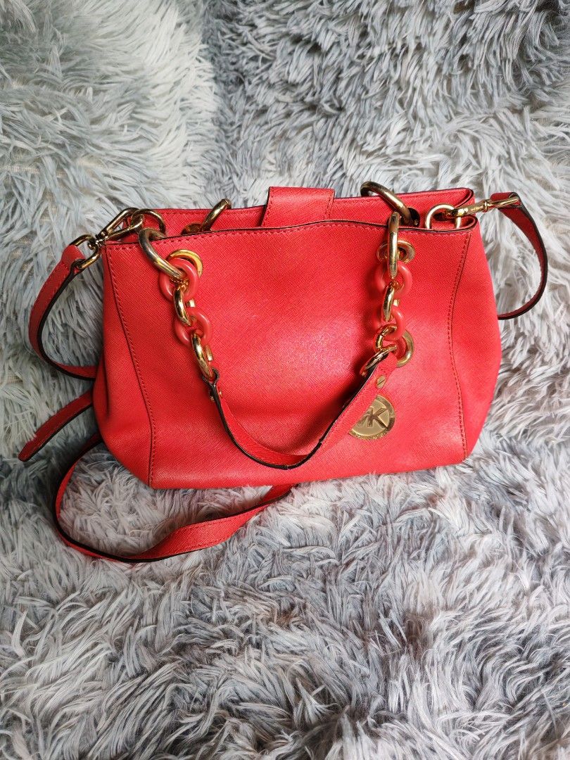 Michael Kors Red Leather Chain Handle Handbag (Category: Luxury Bags & Wallets) located in Manila. Submitted by camellesal67218 (Listing ID 1452186014, Image 1). Description: - Authentic Red Michael Kors Handbag - Genuine Leather Material - Elegant Gold Chain Details - Versatile Crossbody Strap - Spacious Interior with Multiple Compartments - Secure Zip Pocket Inside - Clean Interior Condition - Ideal for Everyday Use or Evening Out.