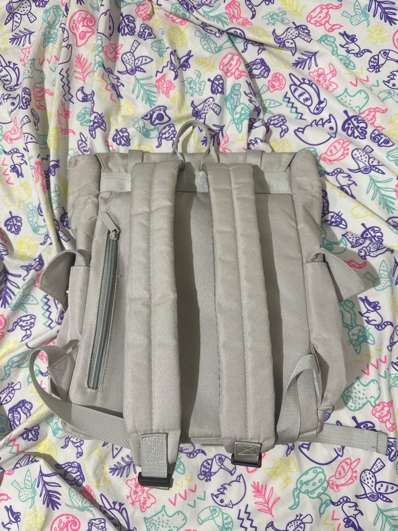 Murioki Light Grey Canvas Backpack (Category: Backpacks) located in Taytay. Submitted by declutter_random (Listing ID 1452122499, Image 2). Description: Light grey murioki canvas backpack. Flap top with buckles and drawstring inside. Back zip pocket, interior zip and slip pockets, side pockets. Perfect for daily use or travel..