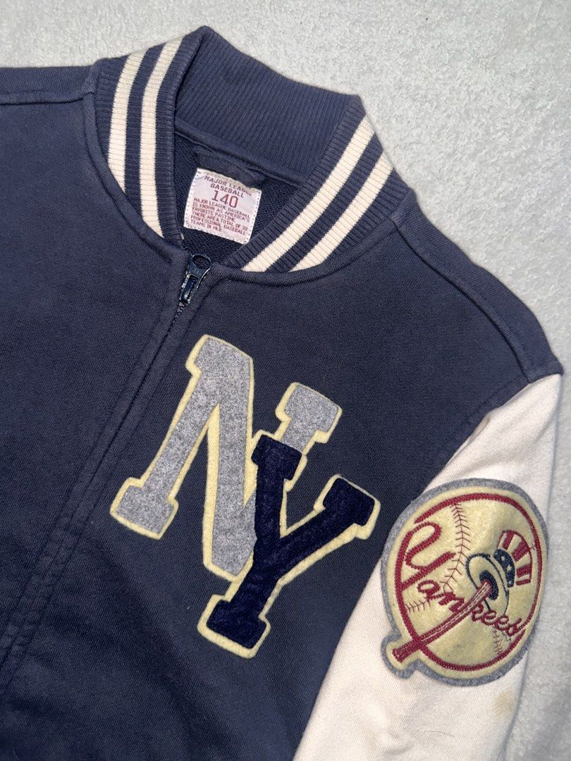 New York Yankees Varsity Jacket Navy Blue White (Category: Coats, Jackets and Outerwear) located in Quezon City. Submitted by mclnd_aj (Listing ID 1452236913, Image 2). Description: - Classic New York Yankees varsity jacket - Navy blue body with white sleeves - Iconic NY logo on the front - "New York Yankees" text on the back - Ribbed cuffs and hem for a snug fit - Full zipper closure - Perfect for any baseball fan! for kids.