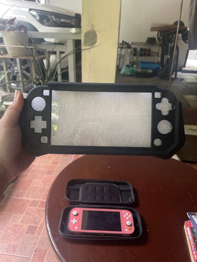 Nintendo Switch Lite Coral with Accessories (Category: Nintendo) located in Caloocan City. Submitted by beeyaatoot (Listing ID 1452285164, Image 3). Description: Nintendo Switch Lite - Animal Crossing: New Horizons Bundle - Isabelle’s Aloha Edition + ACCESSORIES worth almost 1.5k (Lady Owner) and games worth almost 2k Inclusions: -Original Charger -Protective Case (Hard and Silicone) -Storage Case Bag -Thumb Grip Cover -Tempered Glass -Super Mari