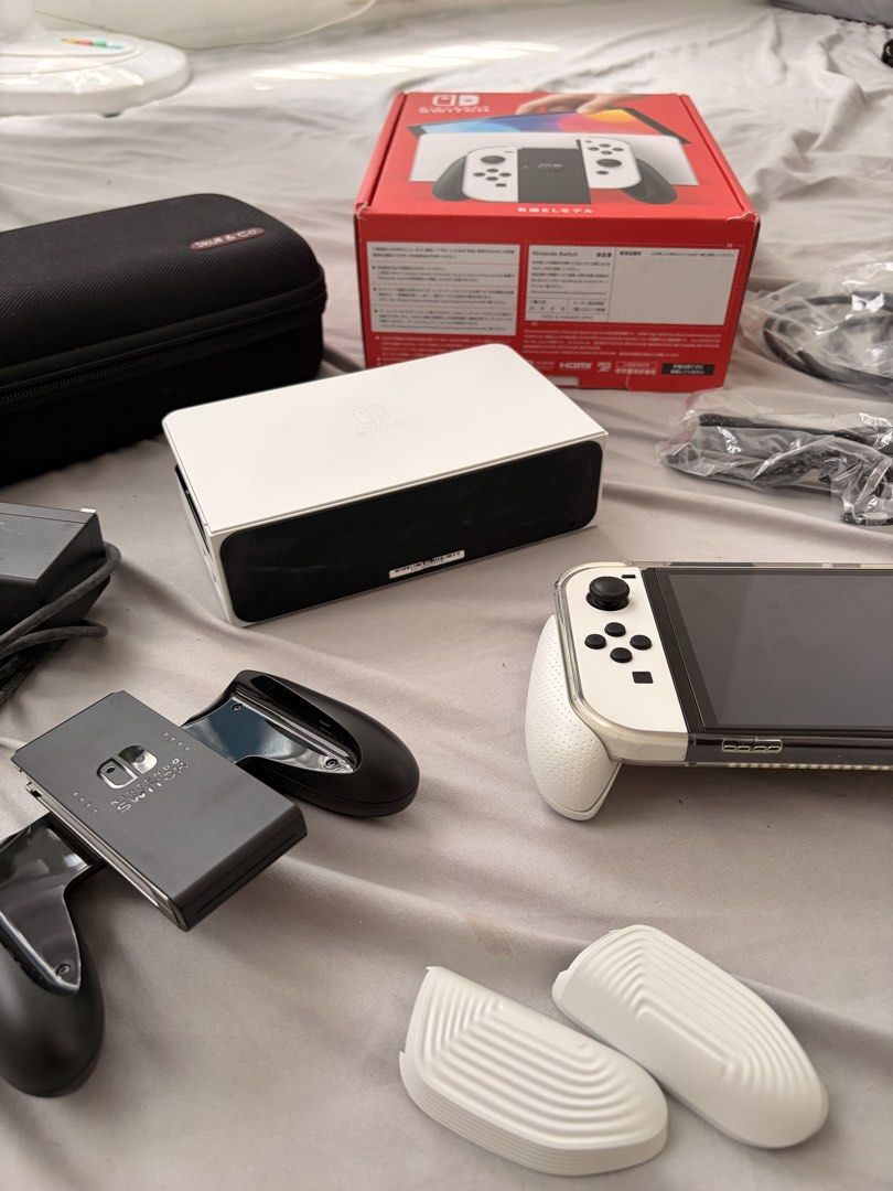 Nintendo Switch OLED White Console with Accessories (Category: Nintendo) located in Malabon City. Submitted by Maktub_01 (Listing ID 1452120187, Image 3). Description: Guaranteed Good as New! - Nintendo Switch OLED Model (White) - Includes original dock and Joy-Cons - Comes with Joy-Con straps and grip accessory - Original box included - Bonus travel hard case for gaming on the go - All necessary cables are provided - Ready for both home console 