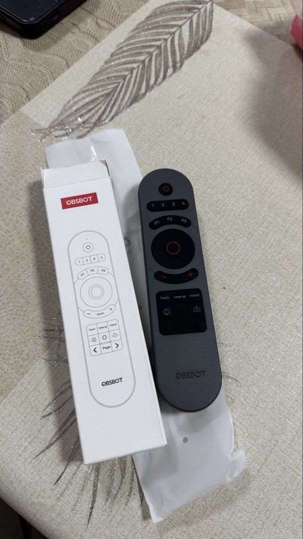 OBSBOT Remote Control (Category: Security Systems & CCTV Cameras) located in Singapore. Submitted by waffleandmuffins123 (Listing ID 1452229122, Image 1). Description: - OBSBOT remote control - Compatible with PTZ cameras - Features tracking and zoom buttons - Comes in original packaging - Ideal for camera setup control.