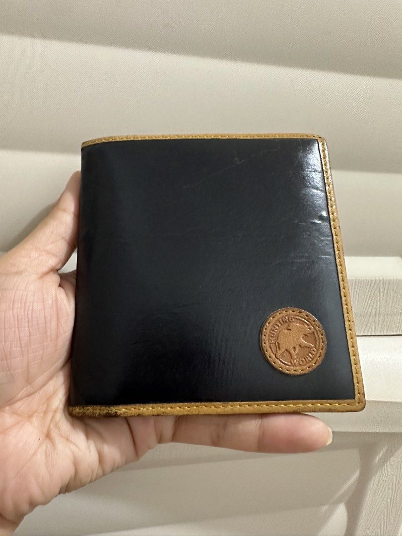 Original Hunting World Leather Bi-fold Wallet (Category: Luxury Bags & Wallets) located in Naga. Submitted by bag.net (Listing ID 1452268142, Image 1). Description: - Brand: Hunting World(from Japan 🇯🇵) - Style: Classic bifold wallet - Exterior: Black leather with tan leather trim - Interior: Tan leather - Origin: Made in Italy - Condition: Shows some signs of wear on edges and interior - Features: Plenty of card slots and compartments.