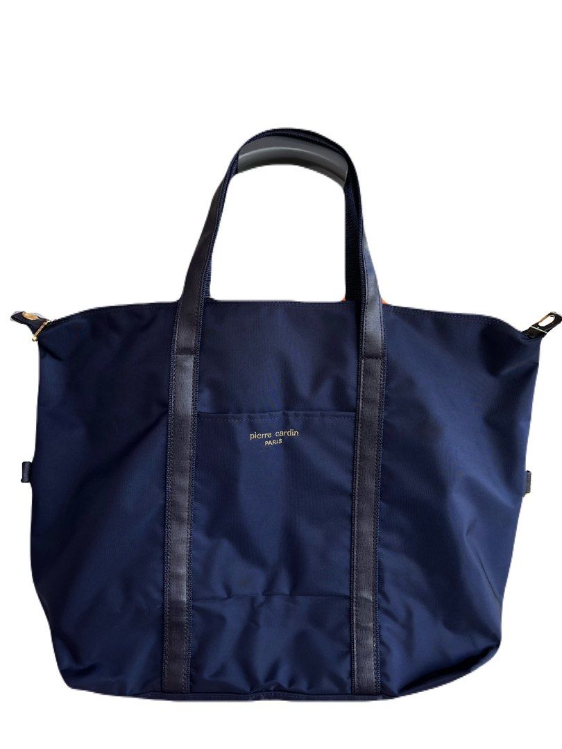 Pierre Cardin Navy Blue Tote Bag (Category: Tote Bags) located in La Trinidad. Submitted by whatnotcollections (Listing ID 1452249873, Image 1). Description: - Unisex tote bag. - Ideal for school, office, weekend getaways or gym sessions and everyday use. - Secure zipper (YKK) closure Approximately (in inches): W: 20” H: 14” Depth: 5.5” It doesn’t have fabric internal label. The lack of an inner fabric tag is actually very common for this specifi