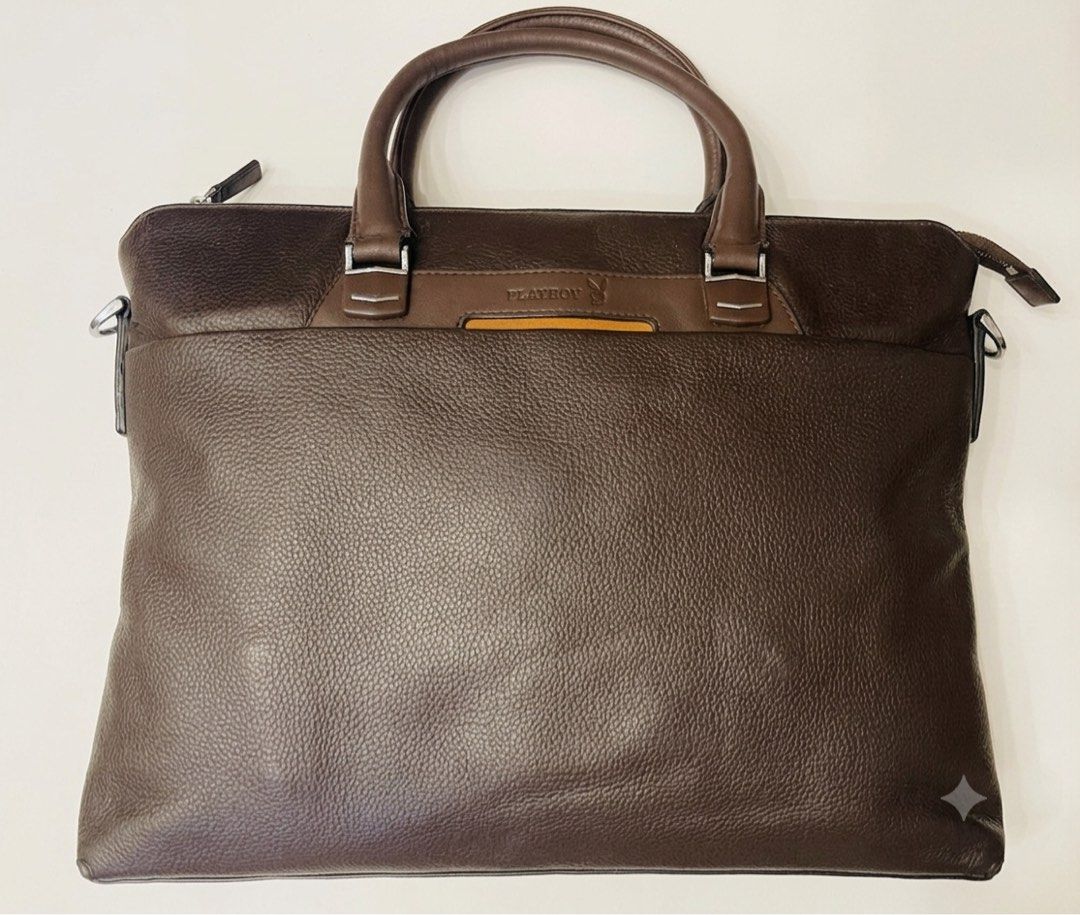 Playboy Men's Leather Briefcase / Laptop Bag (Category: Briefcases) located in Imus. Submitted by cheratedfinds (Listing ID 1452310908, Image 2). Description: Sleek and professional dark brown pebbled finish briefcase with custom Playboy metal hardware and embossed branding. Perfect for daily office work, business meetings, or holding your laptop/documents in style. Spacious main compartment, exterior front slip/zipper pocket, inner zipper pocket