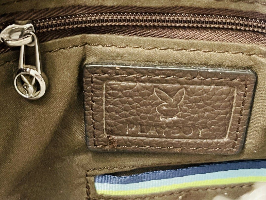 Playboy Men's Leather Briefcase / Laptop Bag (Category: Briefcases) located in Imus. Submitted by cheratedfinds (Listing ID 1452310908, Image 3). Description: Sleek and professional dark brown pebbled finish briefcase with custom Playboy metal hardware and embossed branding. Perfect for daily office work, business meetings, or holding your laptop/documents in style. Spacious main compartment, exterior front slip/zipper pocket, inner zipper pocket