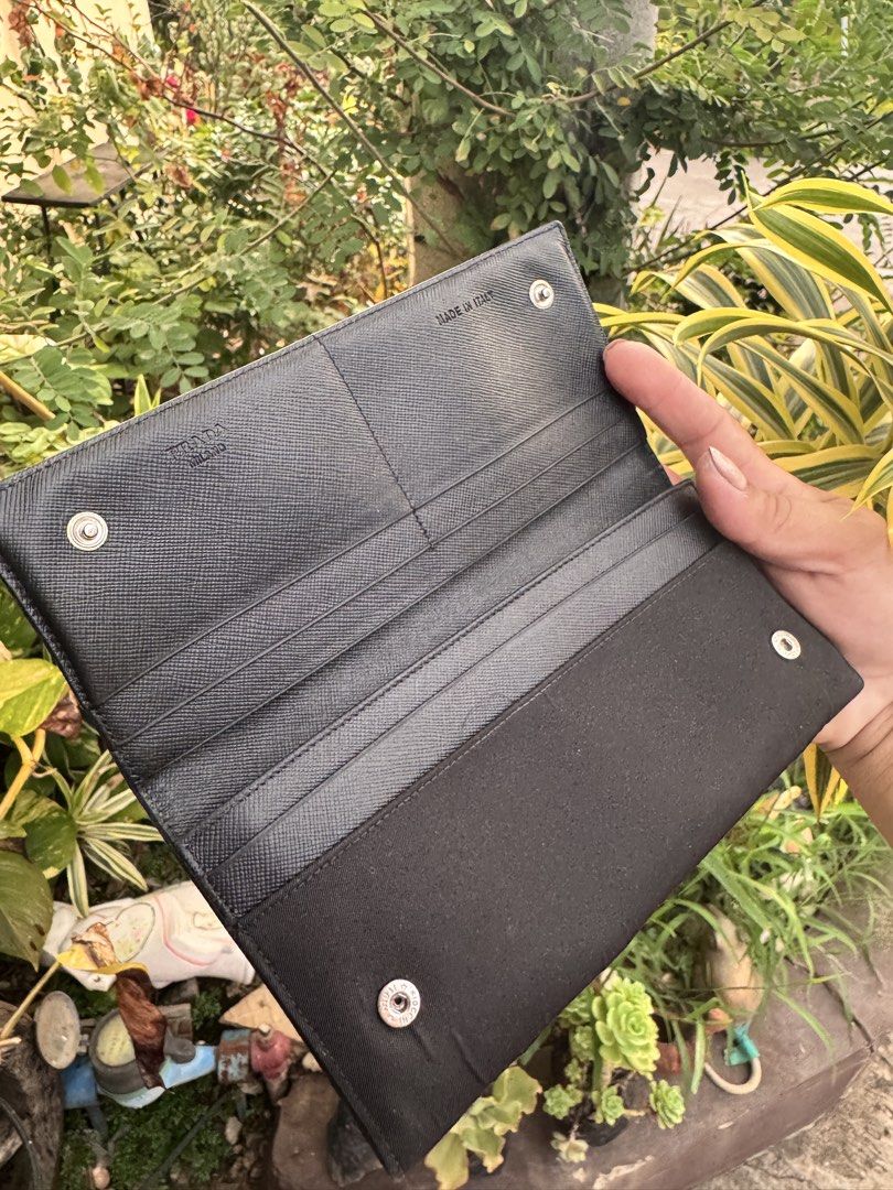 Prada Black Nylon Wallet (Category: Luxury Bags & Wallets) located in Cainta. Submitted by danica010314 (Listing ID 1452277361, Image 3). Description: - Classic black Prada wallet - Made in Italy - Durable nylon exterior with luxurious leather interior - Ample card slots for organization - Zippered compartment for coins or small items - Secure snap closure - Ideal for everyday use.