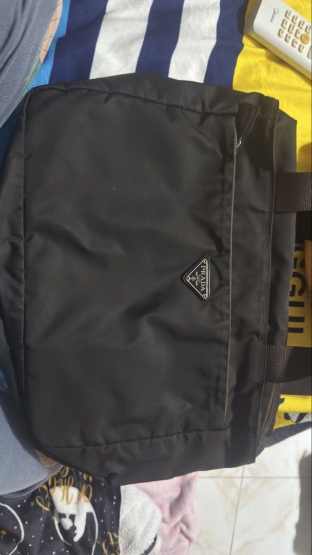Prada Nylon Tote Bag (Category: Luxury Bags & Wallets) located in Pasig City. Submitted by cecilececile4361 (Listing ID 1452254083, Image 1). Description: - Classic Prada tote bag - Durable nylon material - Iconic Prada triangle logo on front - Spacious interior - Comfortable handles - Versatile for daily use.