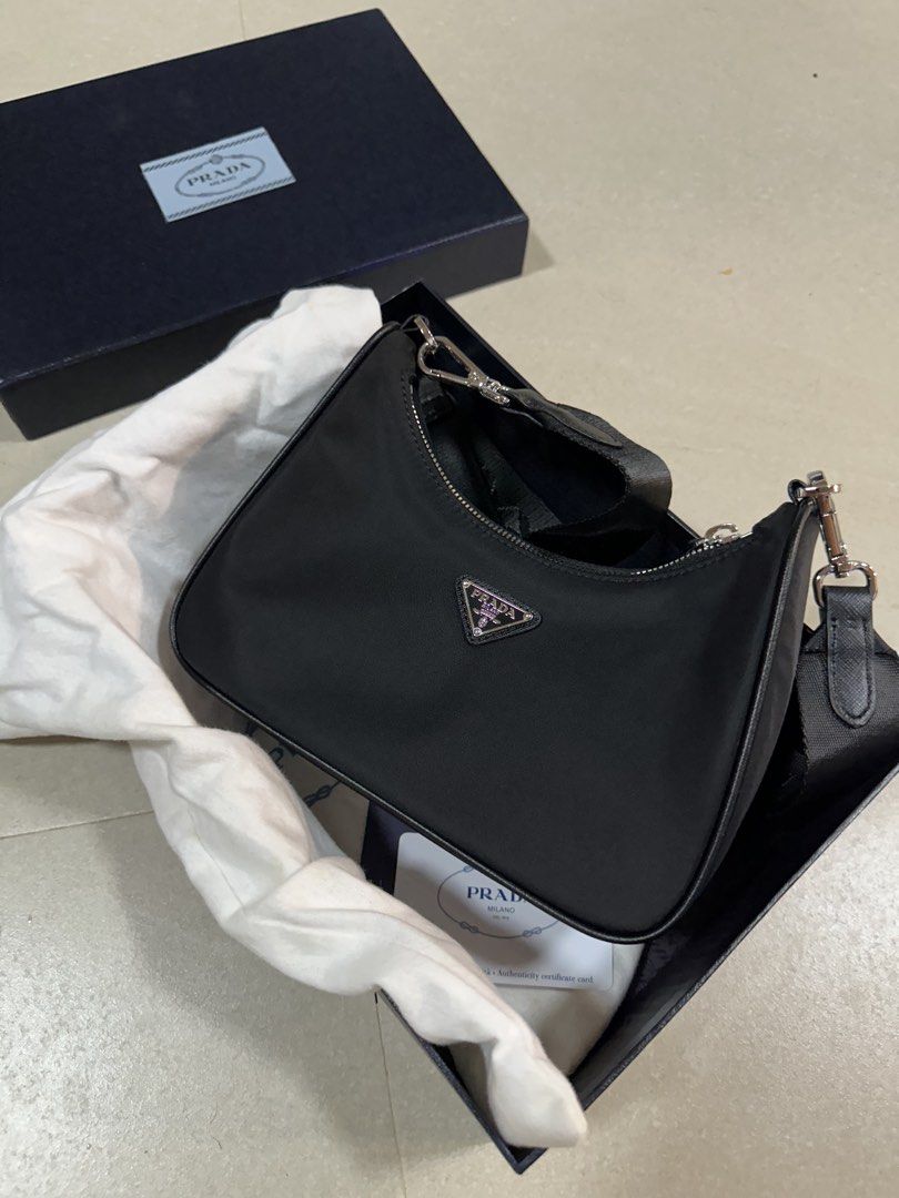 Prada Re-Nylon Mini Bag Black (Category: Luxury Bags & Wallets) located in Manila. Submitted by lei_arcel (Listing ID 1452303960, Image 2). Description: - Authentic Prada Re-Nylon mini bag - Color: Black - Includes original box, dust bag, and authenticity card - Comes with detachable small pouch and chain - Ideal for carrying essentials - Interior and exterior are clean - Shows minimal signs of wear.