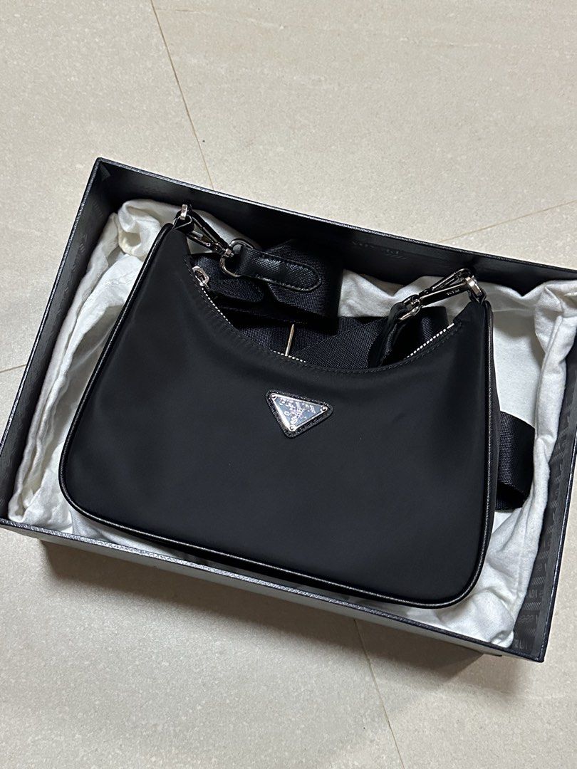 Prada Re-Nylon Mini Bag Black (Category: Luxury Bags & Wallets) located in Manila. Submitted by lei_arcel (Listing ID 1452303960, Image 3). Description: - Authentic Prada Re-Nylon mini bag - Color: Black - Includes original box, dust bag, and authenticity card - Comes with detachable small pouch and chain - Ideal for carrying essentials - Interior and exterior are clean - Shows minimal signs of wear.