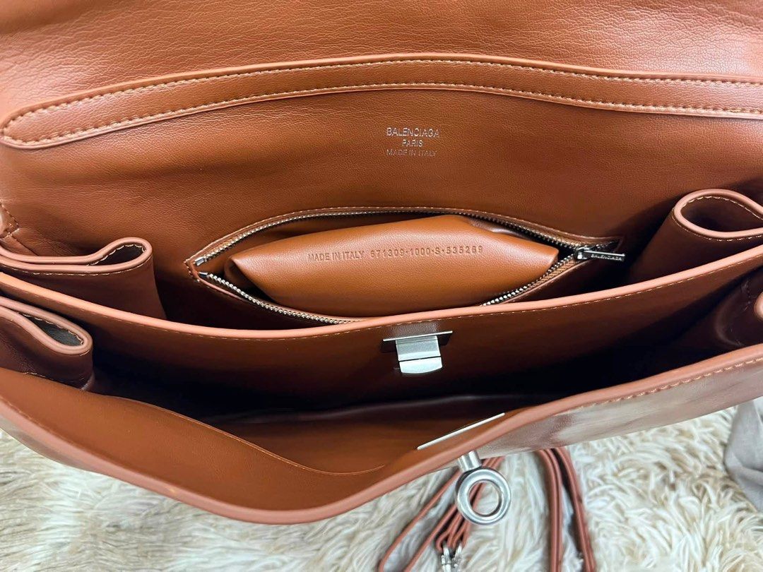 Preloved Rodeo Handbag (Category: Luxury Bags & Wallets) located in Manila. Submitted by bagsandshoesmanymore (Listing ID 1452243908, Image 3). Description: Preloved Balenciaga Tanned Lambskin Handbag One handle Aged-silver hardware Turn lock closure Removable shoulder strap Nappa lambskin lining Made in Italy JAPAN Preloved Size 40cm Please read before you order 👉🏻❗️Payment first before shipping ❗️Cut off time of payment 11am sameday delivery 