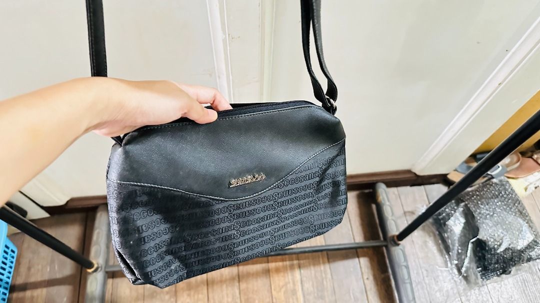 Preloved Secosana Black Textured Crossbody Bag (Category: Cross-body Bags) located in Cebu City. Submitted by annaincebu (Listing ID 1452249593, Image 3). Description: ✅ MEASUREMENTS: Length: 12 inches Width: 8 inches 📦 DELIVERY: Maxim COD (for within Cebu) or LBC or JRS Express (outside Cebu) ✅ NOTES: With flaws (see close-up picture of strap) - Secosana black crossbody bag - Textured pattern with repeated brand name - Main zippered compartment
