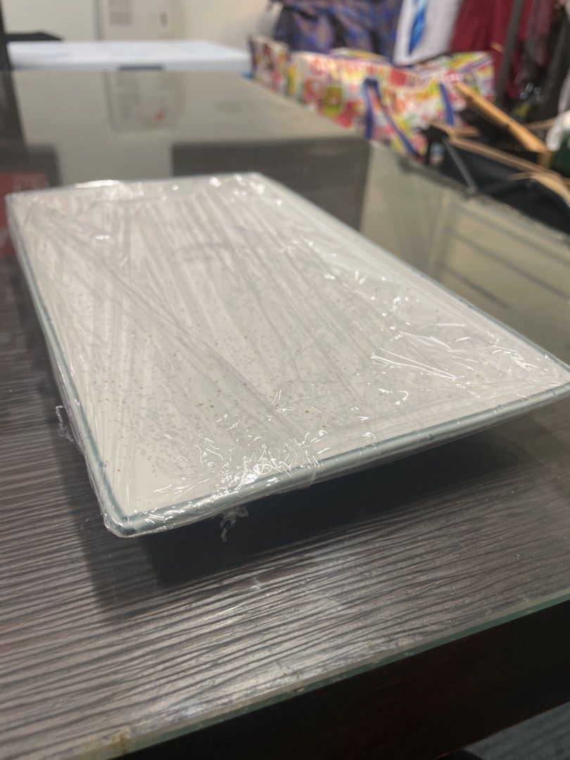 Rectangular serving plate with speckled pattern (Category: Dinnerware & Cutlery) located in Singapore. Submitted by buzzlightyear21 (Listing ID 1452143244, Image 1). Description: - Rectangular serving plate - White with speckled pattern - Light blue trim around the edge - Ideal for serving snacks or appetizers.