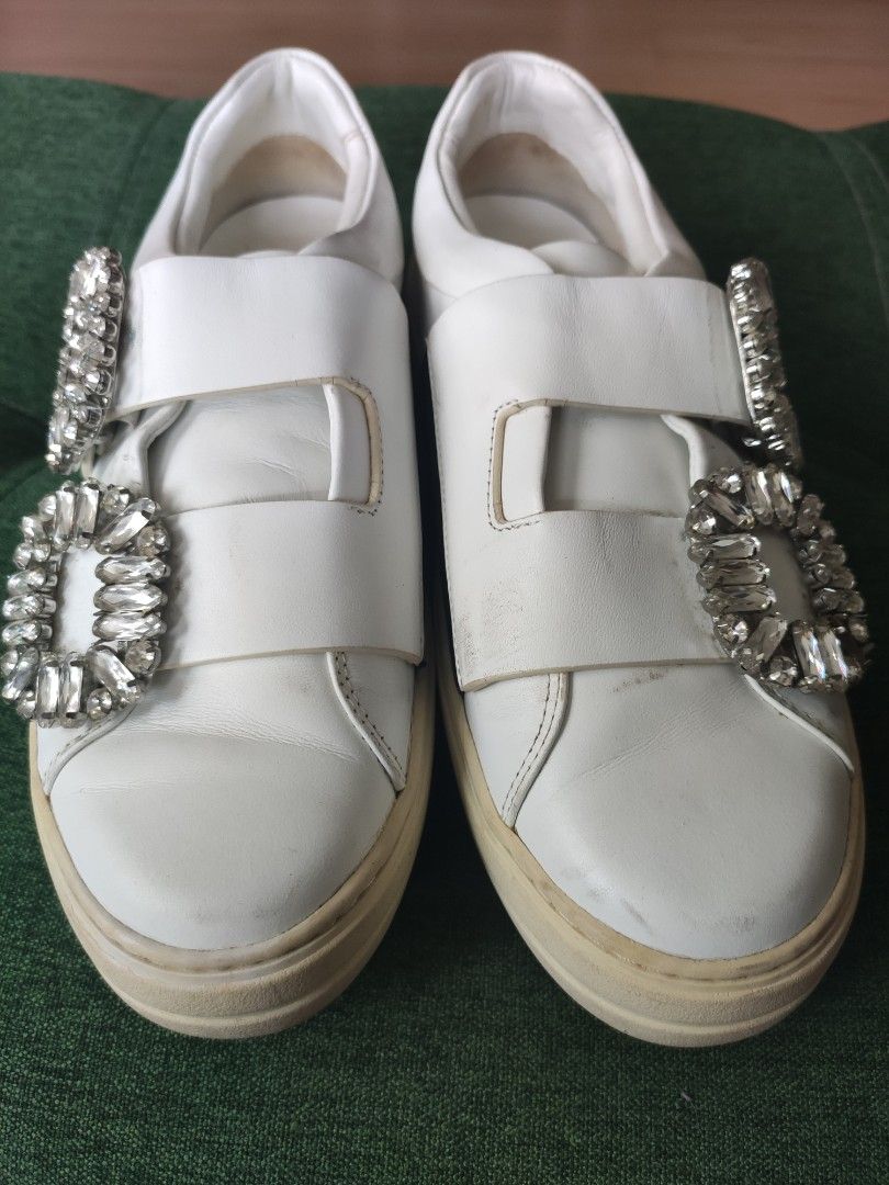 Roger Vivier White Leather Crystal Buckle Sneakers (Category: Sneakers) located in Paranaque City. Submitted by daddyu (Listing ID 1452289521, Image 2). Description: - White leather sneakers - Signature crystal buckle detail - Slip-on style with velcro straps - Comfortable platform sole - Made in Italy - Minor signs of wear on soles and leather.