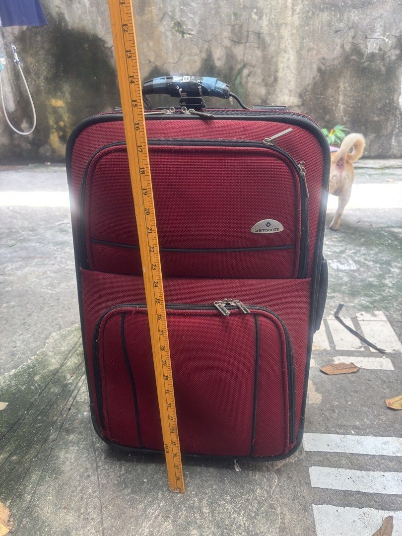 (Samsonite)Samsonite Red Rolling Suitcase Luggage (Category: Luggage) located in Pasig City. Submitted by lhengay (Listing ID 1452168872, Image 2). Description: - Red Samsonite rolling suitcase - Two front zippered pockets - Main compartment - Extendable and retractable handle - Intact wheels - Minor exterior and handle wear consistent with travel - Ideal for short trips or carry-on luggage.