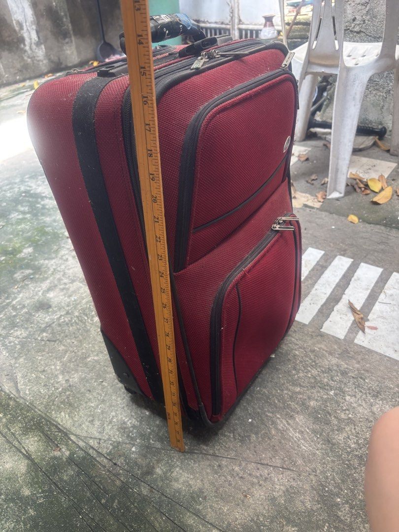 (Samsonite)Samsonite Red Rolling Suitcase Luggage (Category: Luggage) located in Pasig City. Submitted by lhengay (Listing ID 1452168872, Image 1). Description: - Red Samsonite rolling suitcase - Two front zippered pockets - Main compartment - Extendable and retractable handle - Intact wheels - Minor exterior and handle wear consistent with travel - Ideal for short trips or carry-on luggage.