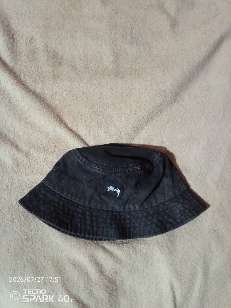 Stussy Bucket Hat (Category: Caps & Hats) located in Bislig. Submitted by micoy22 (Listing ID 1452211990, Image 1). Description: - Classic Stussy bucket hat - Black denim look with white logo detail - Ideal for sunny days or adding style to any outfit - Easy to pack and wear anywhere - A must-have accessory for streetwear enthusiasts.