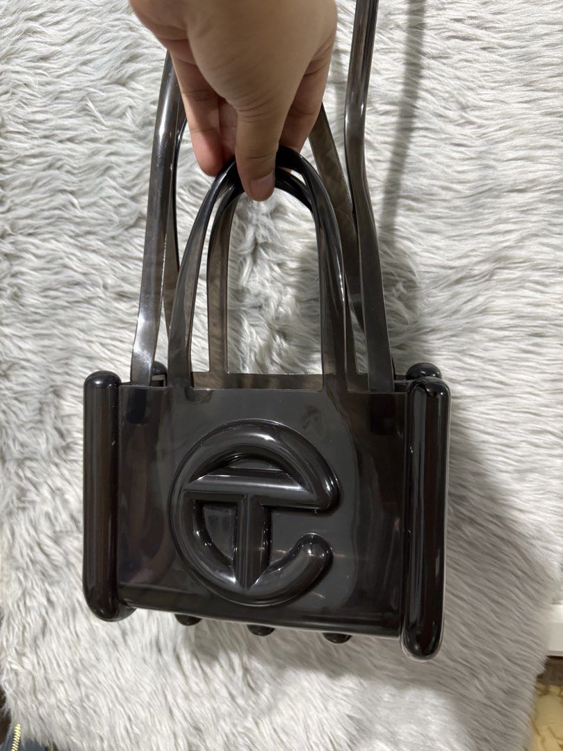 TELFAR x MELISSA SMALL JELLY SHOPPER (Black) (Category: Luxury Bags & Wallets) located in Makati City. Submitted by tarajhing (Listing ID 1452129819, Image 2). Description: Melissa x Telfar black jelly handbag. Iconic Telfar logo. Transparent, small, and compact. Top handles and shoulder strap. Perfect for day or night. Comes with original dust bag. Note: Brand new without tag ***Fixed price, no haggling please..