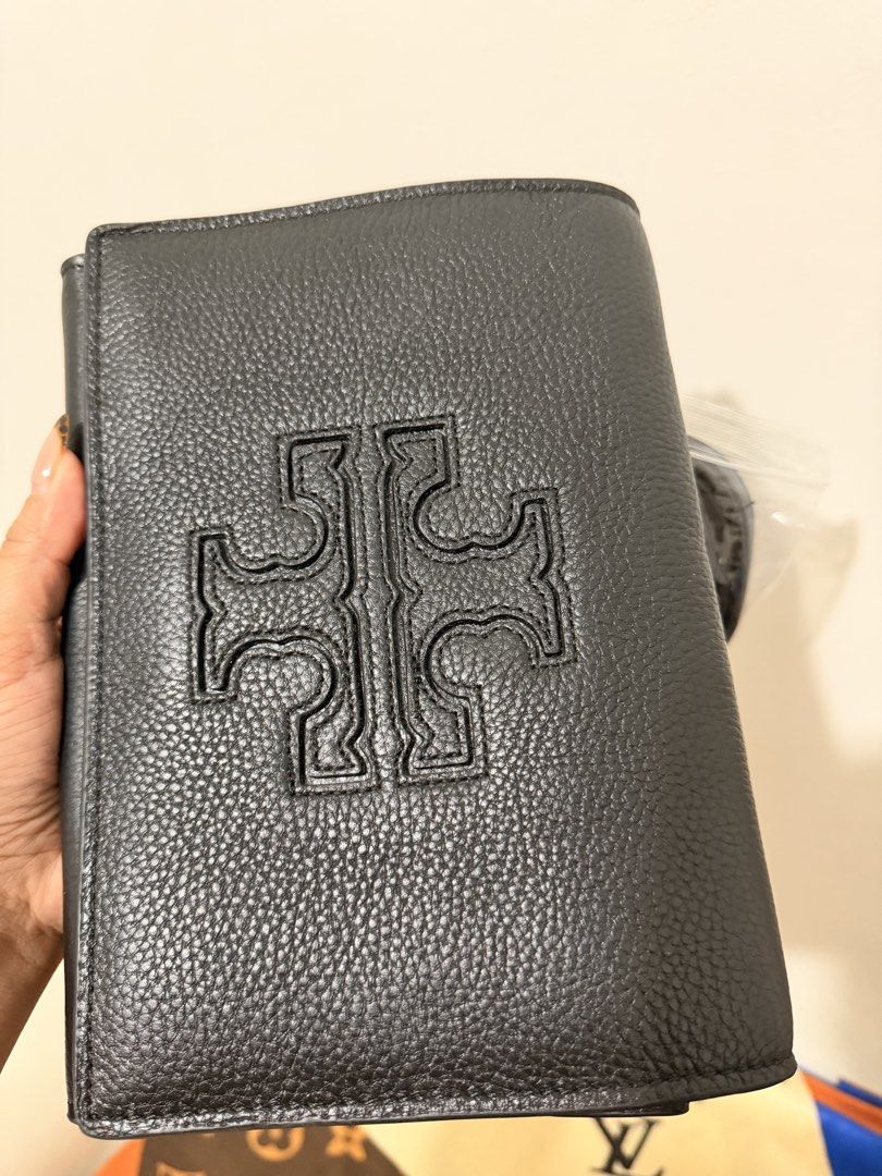 Tory Burch Black Leather Wallet with Strap (Category: Luxury Bags & Wallets) located in Angeles City. Submitted by kimkim_06_614 (Listing ID 1452261947, Image 3). Description: - Brand: Tory Burch - Material: Black pebbled leather - Design: Embossed signature T logo - Features: Detachable leather strap with gold hardware - Interior: Zip pocket and multiple card slots - Condition: Clean inside and out - Perfect for carrying your essentials.