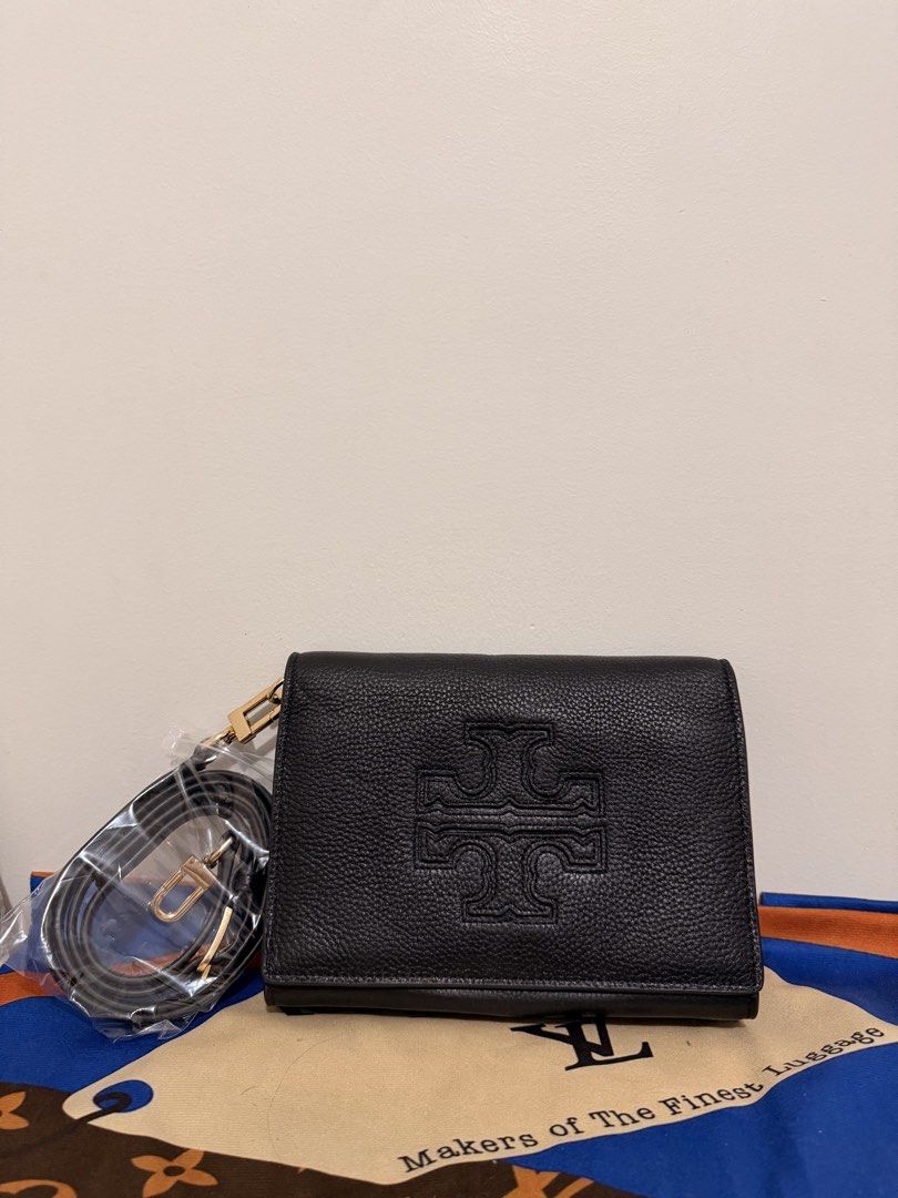 Tory Burch Black Leather Wallet with Strap (Category: Luxury Bags & Wallets) located in Angeles City. Submitted by kimkim_06_614 (Listing ID 1452261947, Image 1). Description: - Brand: Tory Burch - Material: Black pebbled leather - Design: Embossed signature T logo - Features: Detachable leather strap with gold hardware - Interior: Zip pocket and multiple card slots - Condition: Clean inside and out - Perfect for carrying your essentials.