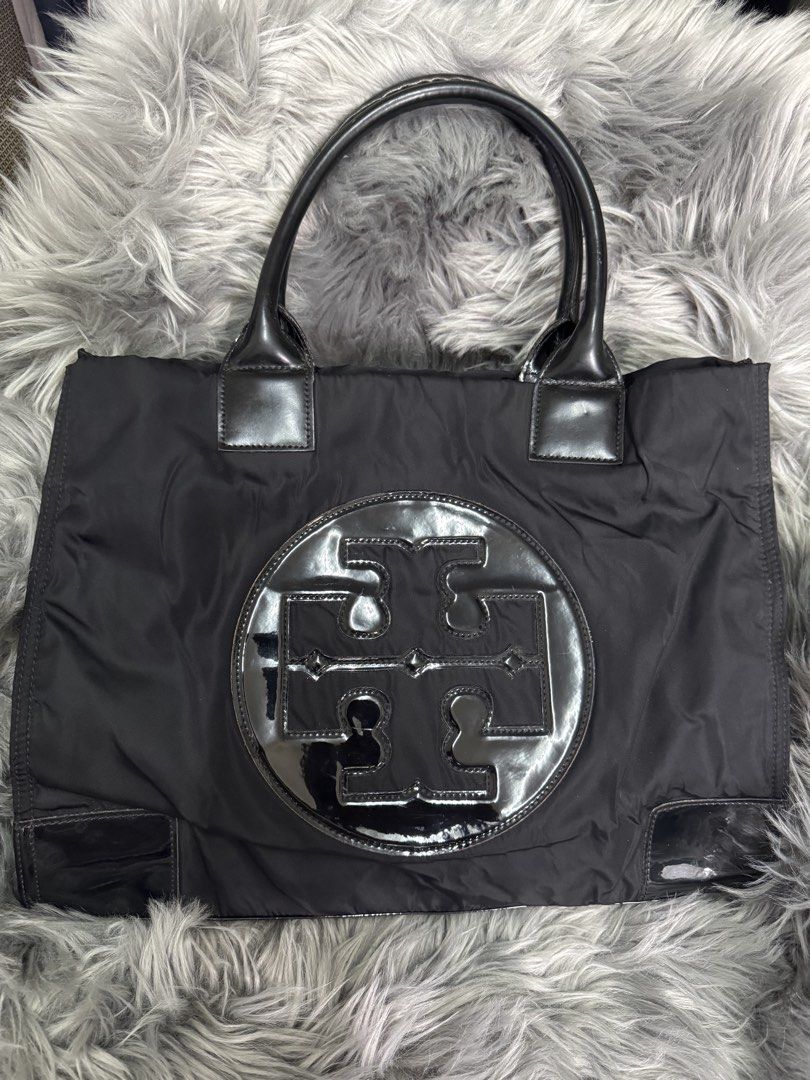 Tory Burch “Ella” Black Nylon Tote Bag (Category: Luxury Bags & Wallets) located in Muntinlupa City. Submitted by rareocean_07898a (Listing ID 1452171043, Image 1). Description: - Authentic Tory Burch top handle tote bag - Black nylon material with patent leather trim and handles - Features the iconic Tory Burch logo on the front - Spacious interior for all your essentials - Ideal for everyday use or travel - Condition: Very good - Dimension: H 1
