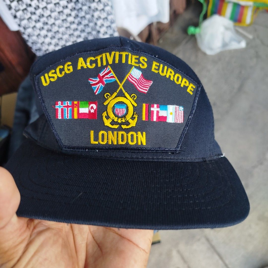 USCG Activities Europe London Snapback Cap (Category: Caps & Hats) located in Davao. Submitted by vernoneighty4 (Listing ID 1452264159, Image 1). Description: - Navy blue snapback cap - Features 'USCG Activities Europe London' embroidery with flags - Made by Northstar (established 1976) - Adjustable strap at the back - Made in USA - Perfect for USCG collectors and memorabilia enthusiasts.