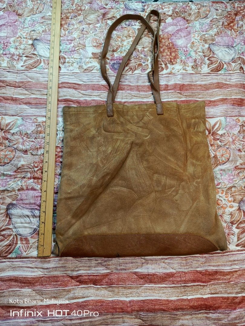 Vintage LongCham (Category: Tote Bags) located in Kuala Lumpur. Submitted by grandturtle_dd5ca3 (Listing ID 1452279110, Image 2). Description: Material: Main body made of genuine tan/brown split suede leather, paired with a matching smooth grain leather base trim and twin shoulder straps. Closure: Features a central metallic snap button/toggle closure strap mechanism typical of vintage Longchamp luggage designs. Dimensions: Measuring alongside th