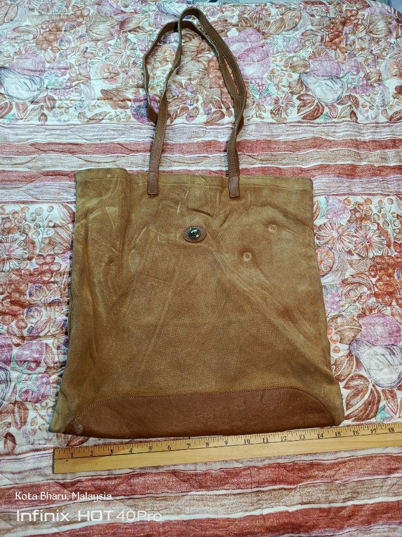 Vintage LongCham (Category: Tote Bags) located in Kuala Lumpur. Submitted by grandturtle_dd5ca3 (Listing ID 1452279110, Image 1). Description: Material: Main body made of genuine tan/brown split suede leather, paired with a matching smooth grain leather base trim and twin shoulder straps. Closure: Features a central metallic snap button/toggle closure strap mechanism typical of vintage Longchamp luggage designs. Dimensions: Measuring alongside th