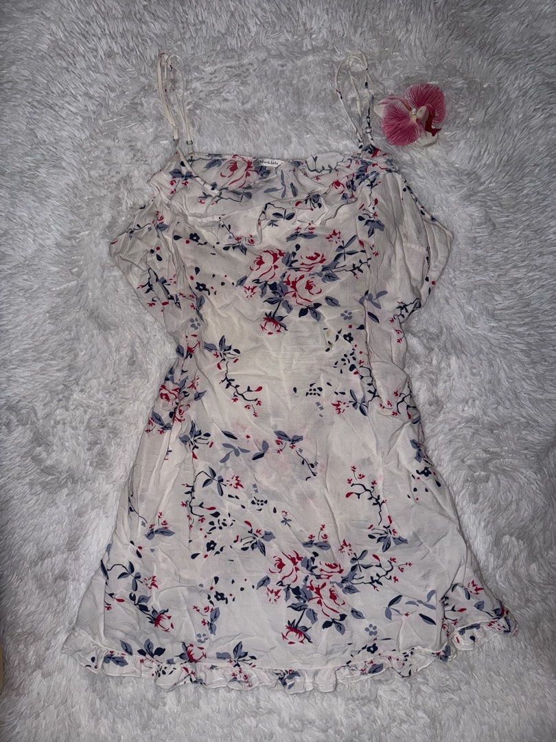 White Floral Spaghetti Strap Mini Dress (Category: Dresses) located in Lipa City. Submitted by princesstrina (Listing ID 1452156252, Image 1). Description: - Cute white mini dress - Features a floral print with red and blue flowers and green leaves - Spaghetti straps - Ruffled hem - Lightweight fabric, perfect for summer - Easy to wear and style.
